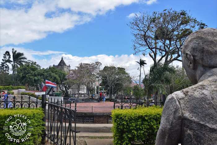 Stone statue overlooking Heredia's central park