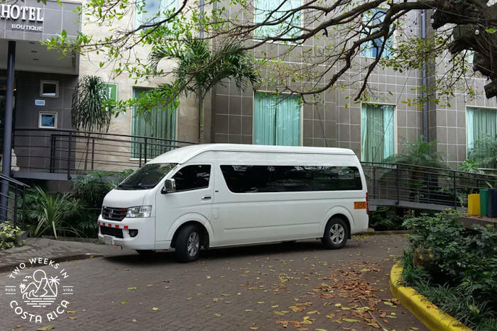 white shuttle van in front of hotel